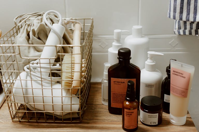 neatly arranged bathroom toiletries and storage items on a wooden surface featuring cosmetics and a hair dryer. 10574132 Neatly arranged bathroom toiletries and storage items on a wooden surface, featuring cosmetics and a hair dryer.
